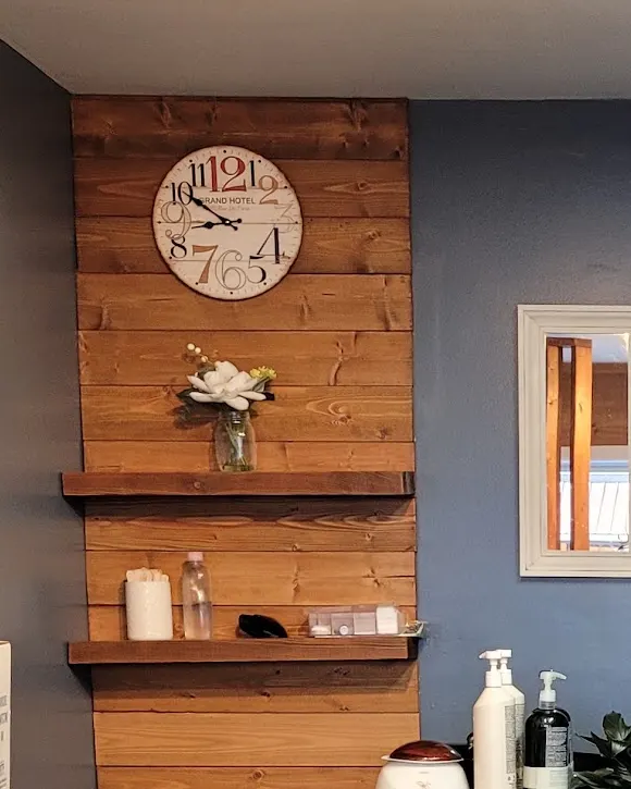 The Grand Hotel station clock on the salon's stained pine plank wall