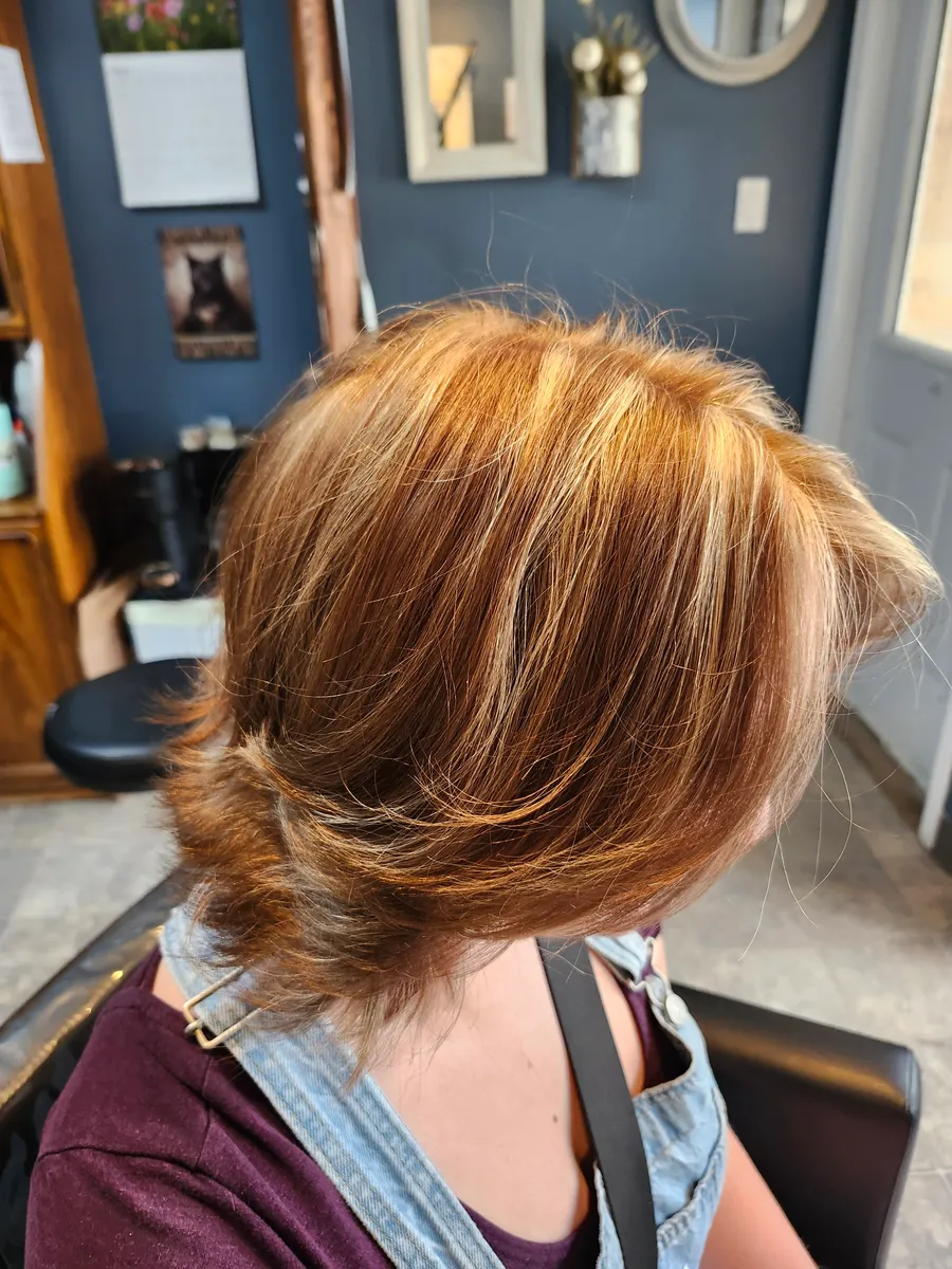 A short bob seen from above, copper and gold ribbons woven through the crown